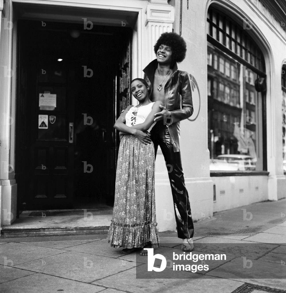 Black teenage boys and girls wearing fashion during a photo shoot.