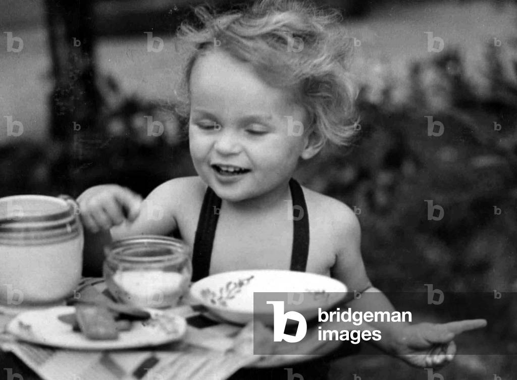 Young girl having a tea party. c. 1945