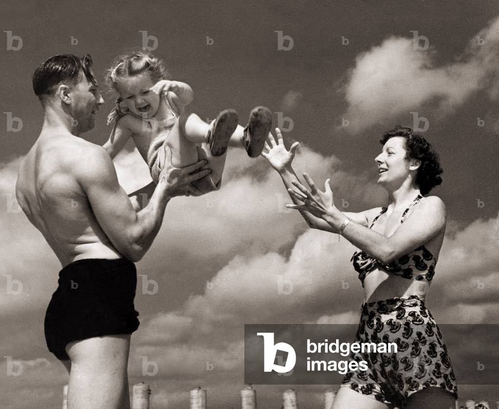Mr and Mrs G T lock with their daughter Judith Anne on holiday at Sandwich Bay, 31st July 1947 (b/w photo)