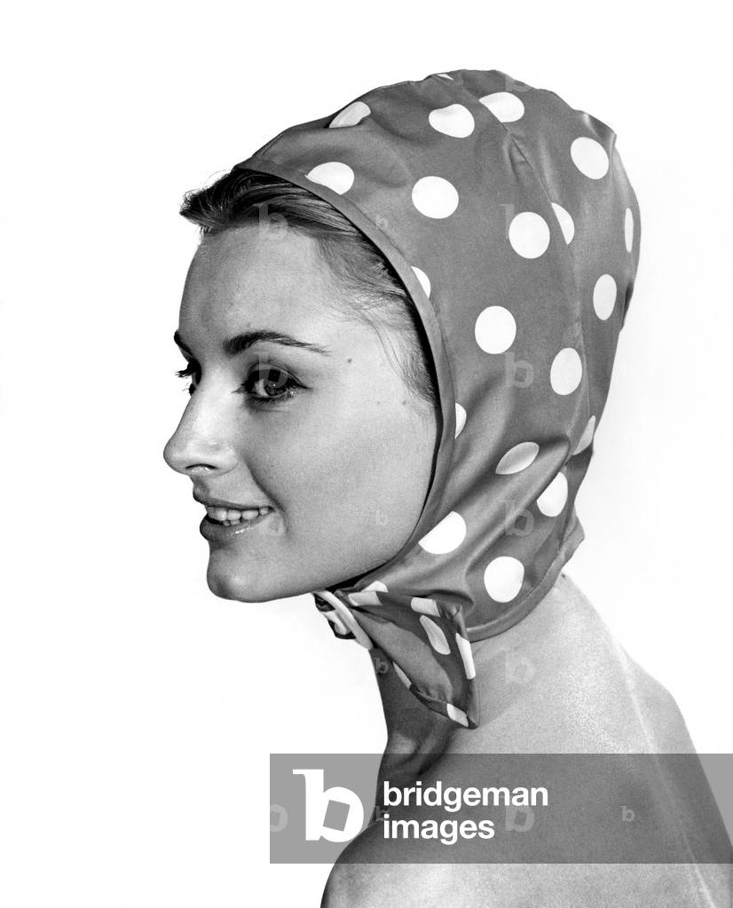 Reveille Fashions 1964, Margaret Lorraine modelling a polka dot scarf, 8th July 1964 (b/w photo)