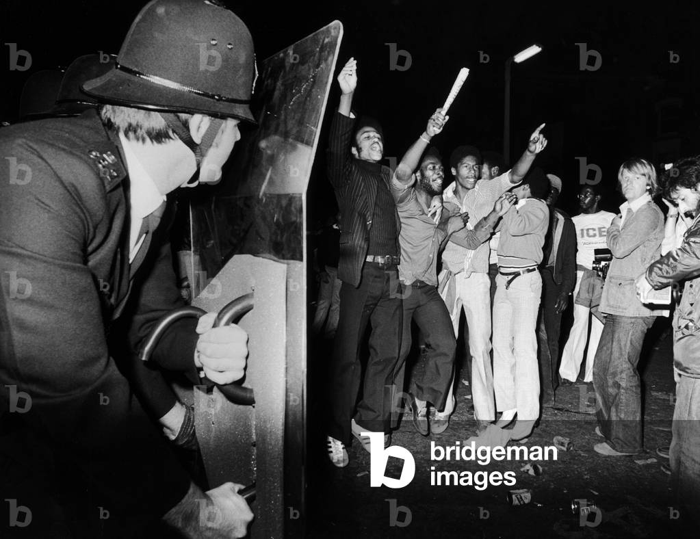 Policemen seen here deploying riot shields as trouble flares up at the end of the 1978 Notting Hill Carnival. 28th August 1978