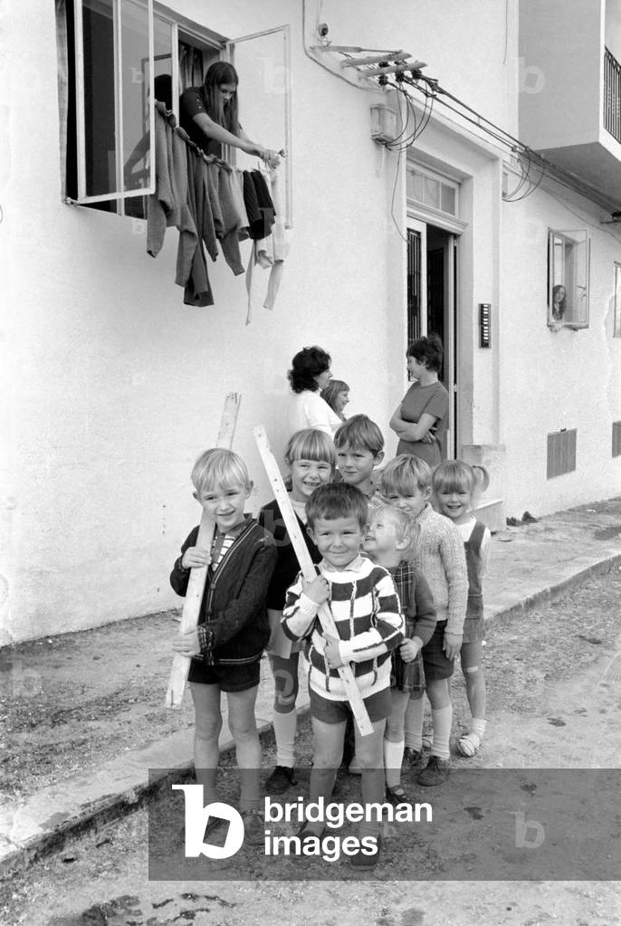 Preparation for the British Departure from Malta. Kids Army. Life for children on Malta is very much the same fun and games. Pictured here are front L-R Graham Felks from Bradford, his father is in the Royal Engineers, and 4 year old Paul Toovey from Norwich, his father is in the Royal Signals, with the rest of their 'Army' marching outside the flats where they live. January 1972