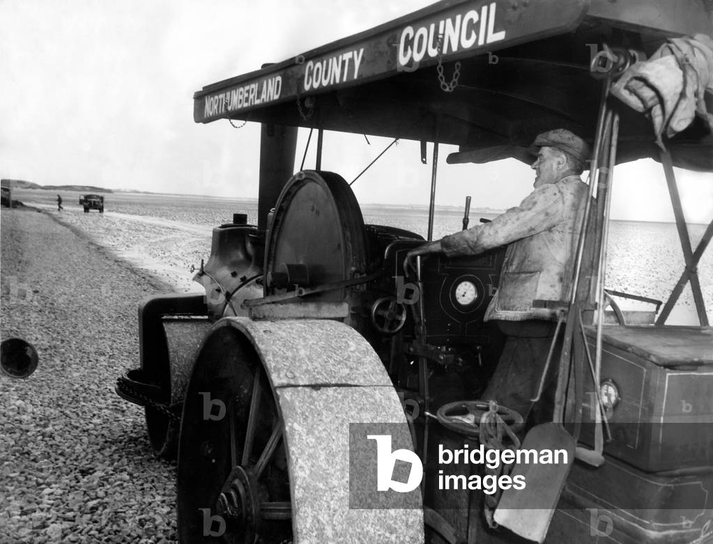 Bill Harmeston uses a Northumberland County Council steam roller to level out the track for the causeway between Holy Island (Lindisfarne) and the mainland.
 20th May 1954.