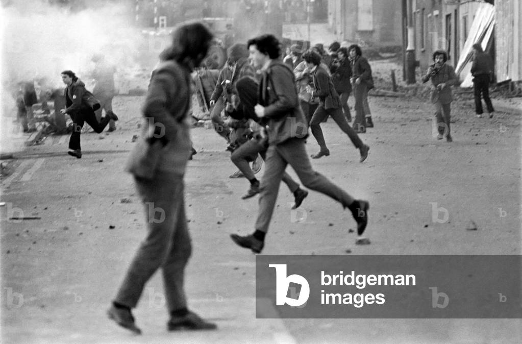 Demonstrators pelt the army with stones following a civil disobediance march through Belfast.