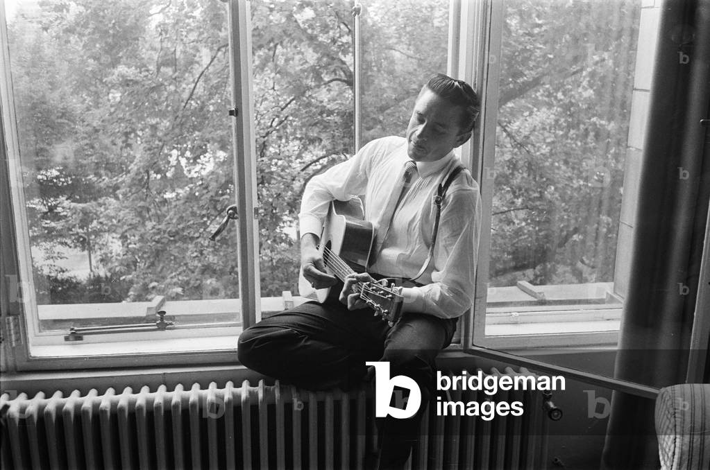 American country singer and musician Johnny Cash poses for photographers at the Savoy Hotel in London. 17th September 1959 (b/w photo)