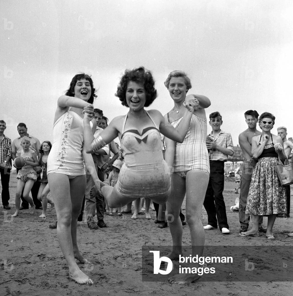 Beauty contest girls at Hunstanton, UK. seen here having some fun on the beach 5th August 1959 (b/w photo)