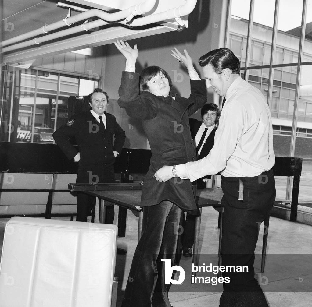 Snooker player Alex 'Hurricane' Higgins being searched at London Airport. 6th May 1973 (b/w photo)