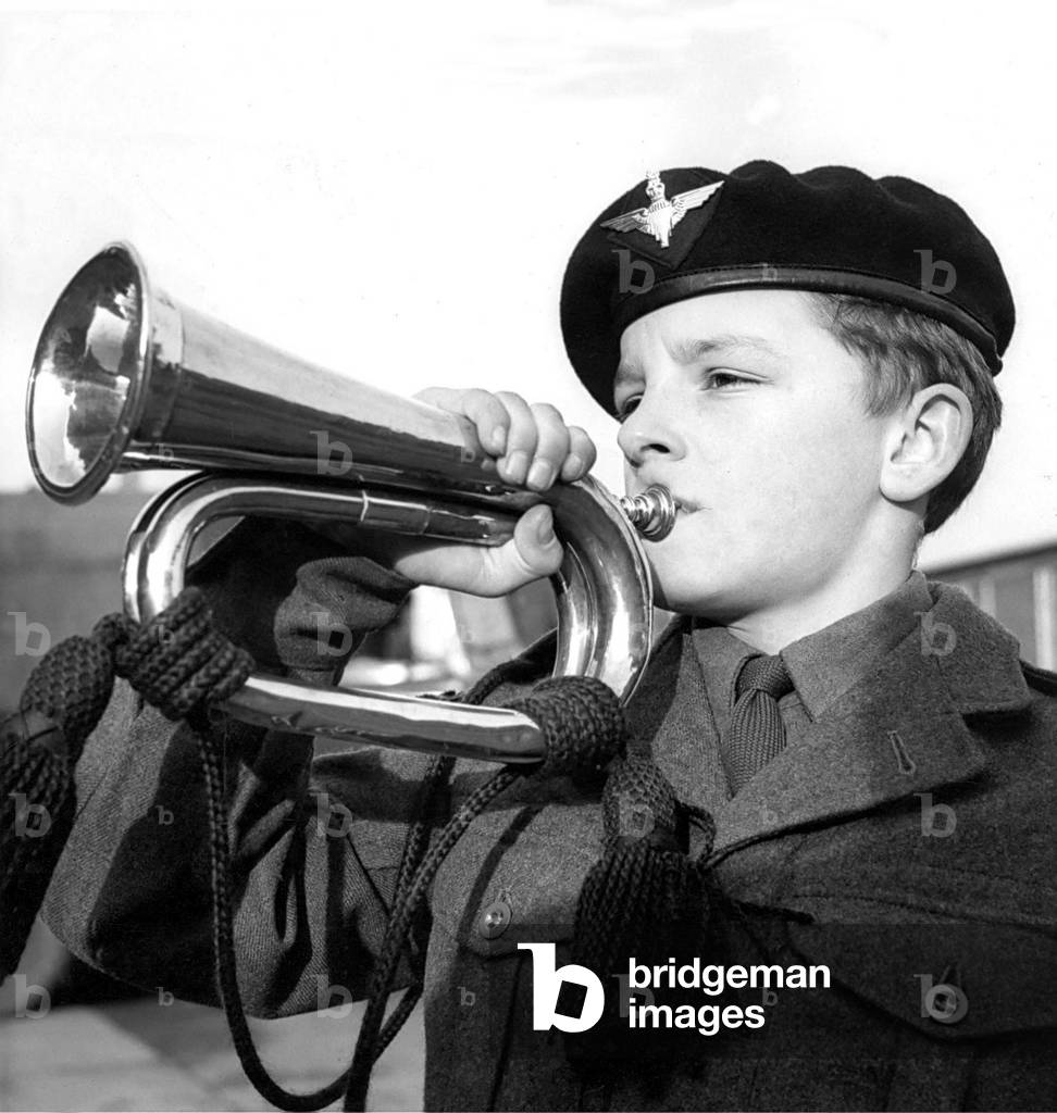 Philip Hall getting a tune from his copper bugle, December 1962 (b/w photo)
