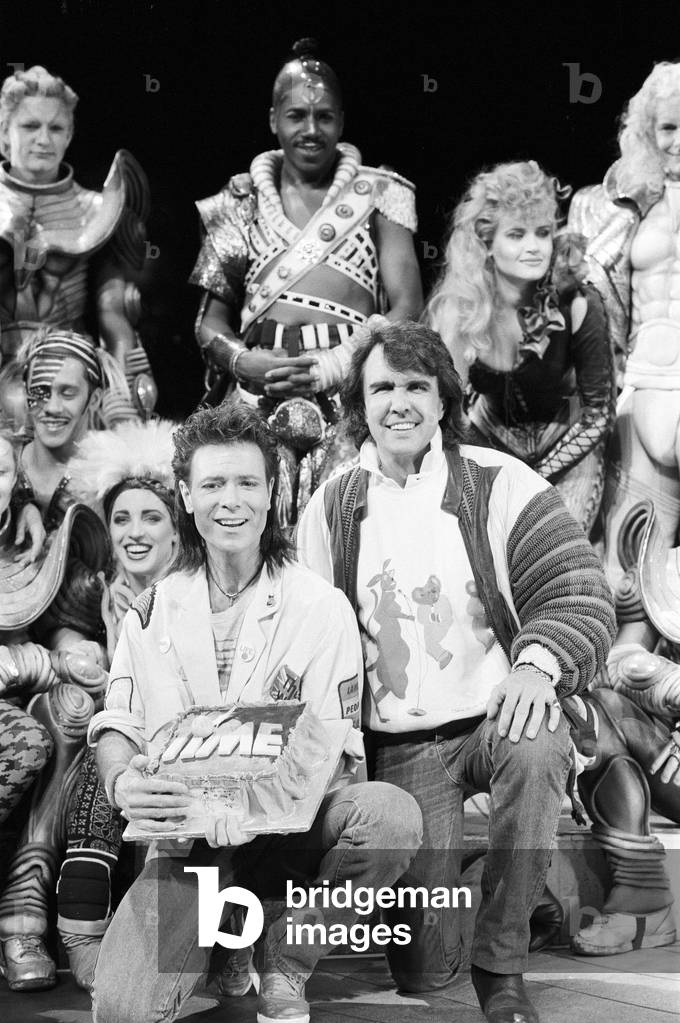 Cliff Richard, Dave Clark and the cast of the musical 'Time' attend a photocall held at the Dominion Theatre. 25th March 1986 (b/w photo)