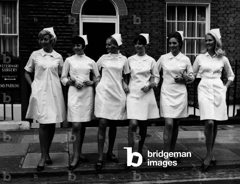 Models displaying six modern style white dresses for nurses at the London Nursing Exhibition. 14th October 1969 (b/w photo)