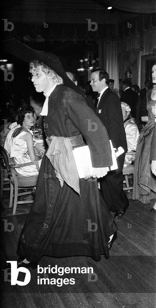 George Henry Hubert Lascelles, 7th Earl of Harewood, attends the Opera Ball at the Dorchester Hotel, Lord Harewood is dressed in a clergyman's outfit, February 1960 (b/w photo)