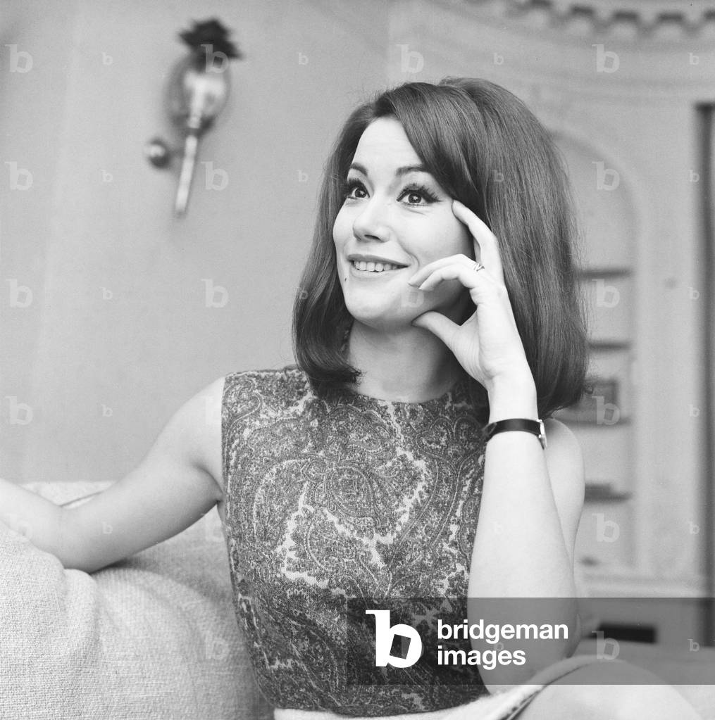 Parisienne actress Claudine Auger who will play Domino in the James Bond film Thunderball, seen here during an interview with the Daily Mirror show business reporter Donald Zec. 17th February 1965 (b/w photo)