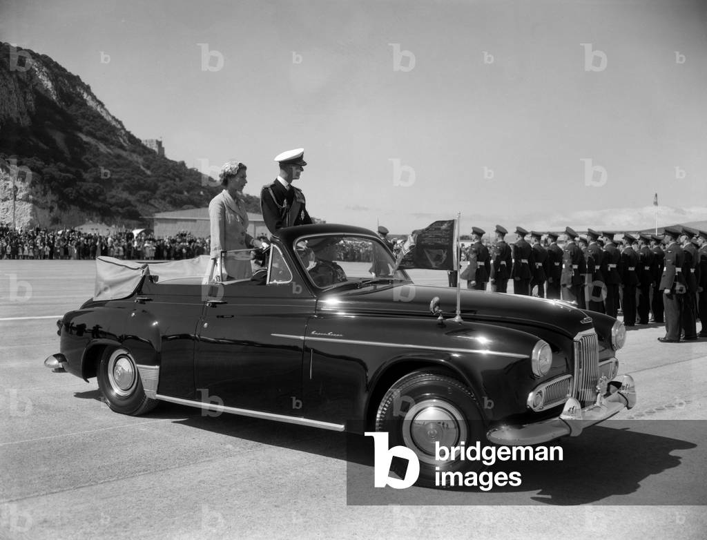 Queen Elizabeth II and Prince Philip at Windsor Castle with her corgi, Sugar, 1950 (b/w photo)