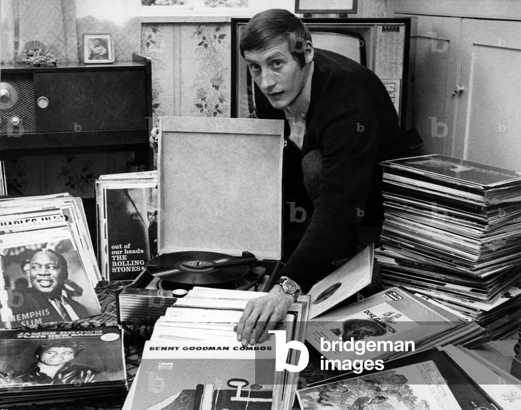 Mr. Colin Tustin at home in Hythe Bridge St. Oxford seen cleaning some of his 486 long playing jazz records. Vinyl. Music. 
July 1966
