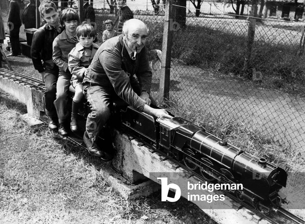 Mr. Matt Copeman busy at the controls of one of the locomotives belonging to the Chester-Le-Street Model Engineering Society at their permanent lay-out at the town's Riverside Park on 4th June 1972 (b/w photo)