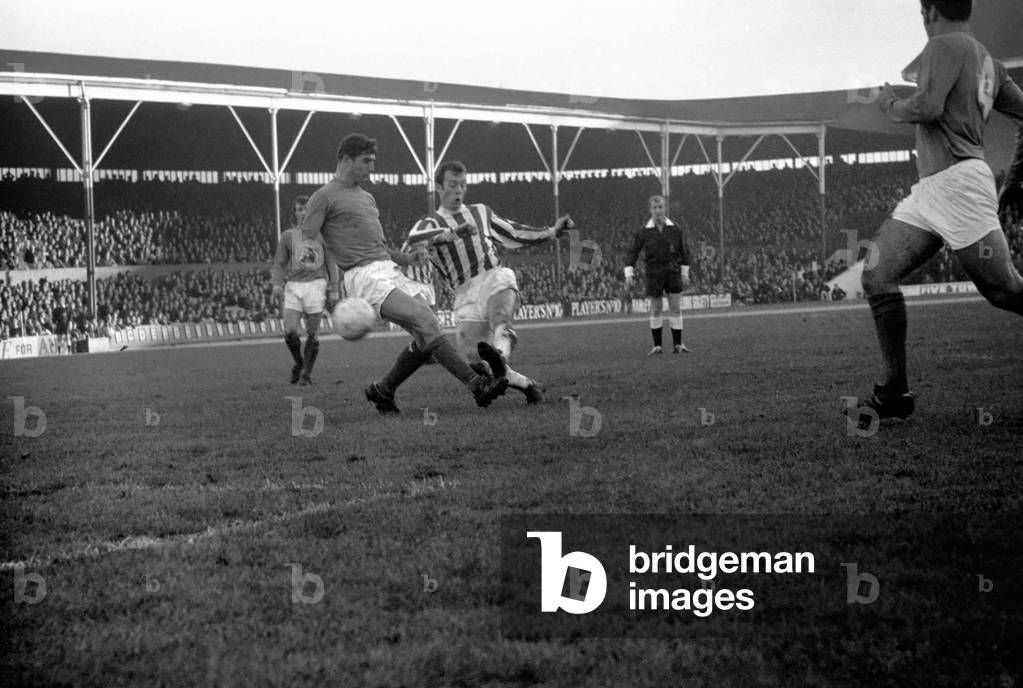 Sport. Football. English League Division One match. Stoke v. Ipswich. Burrows - Stoke winger puts a shot past Ipswich half back McNeil to scors the first goal. December 1969 (photo)
