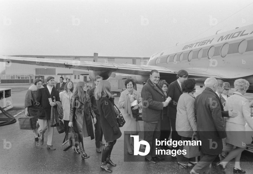 The first plane load of Christmas trippers to fly direct from Coventry to Majorca left yesterday. They could be swimming on Christmas Day and have a turkey dinner on the beach. The 78 holidaymakers were warmly wrapped in winter coats and boots as they waited for their 3.50 pm flight to Palma. But inside their bulging suitcases were all the summer holiday trappings - summery dresses, lightweight suits, sandals and bikinis - all ready to be swapped during their five-day visit. Pamela Foster (19), a secretary at Massye-Ferguson, wasn't too hopeful about the Majorgan temperatures after speaking to a Spanish pilot at the airport. 