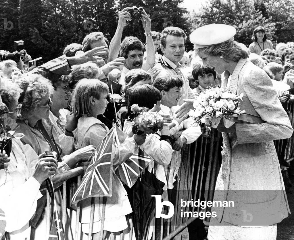 Diana, Princess of Wales during a visit which took in Southfields, a group of sheltered homes for the elderly in Leamington, lunch at the Judges' House followed by a visit to the castle in Warwick. She is seen here during a walkabout in Leamington. 8th July 1986 (b/w photo)