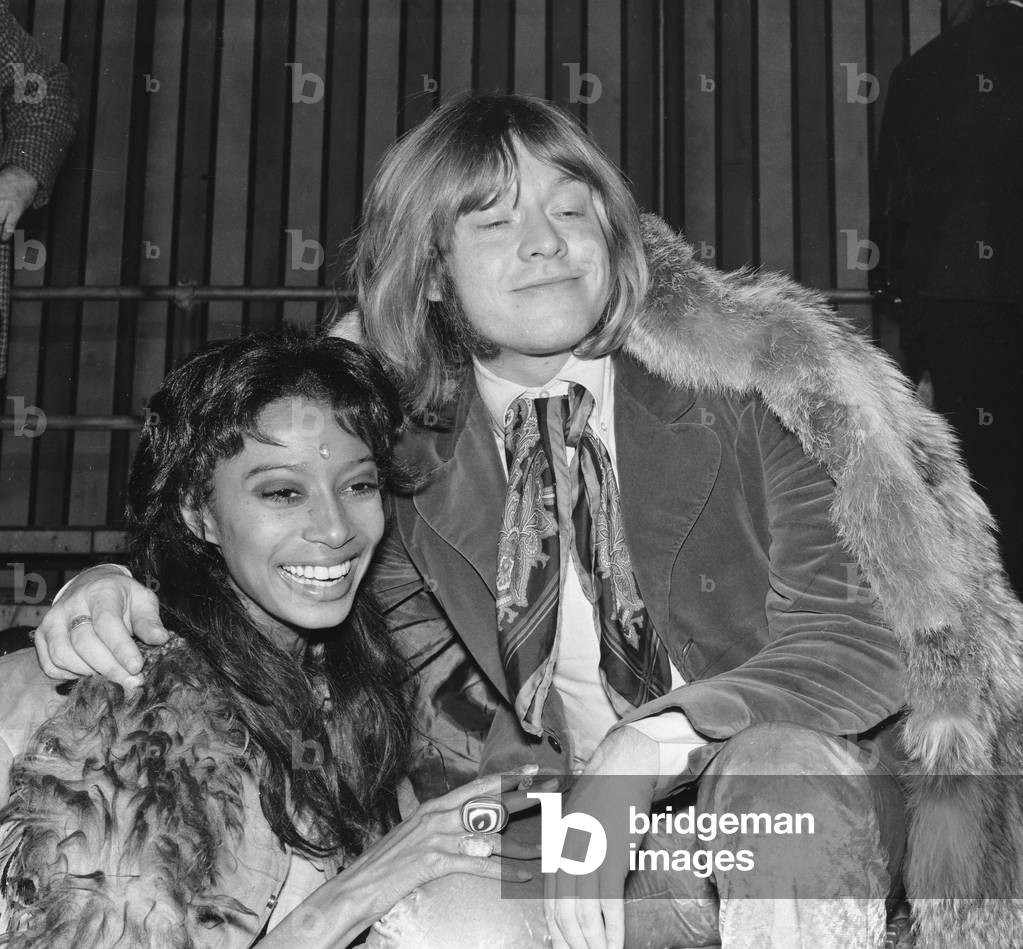 Rolling Stones: Brian Jones at the filming of the Rolling Stones Rock 'n' Roll Circus, which turned out to be his final public appearance with the Stones. He is pictured with model Donyale Luna who played the part of the fire eaters assistant in the Rock 'n' Circus, 11th December 1968 (b/w photo)