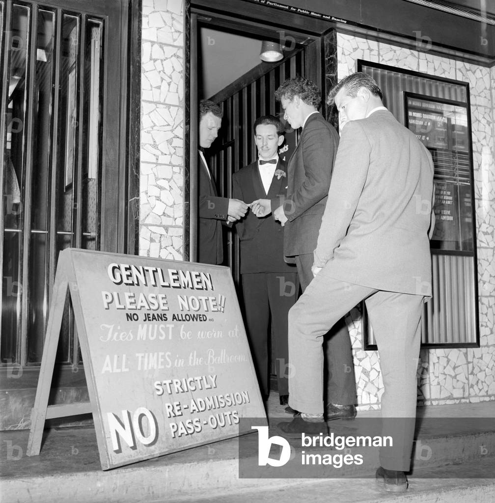 Teenager Fashions: Male Grooming: The teenage boys who go to the Ilford Palais have had to change their style of dress since the introduction of a formal dress code. October 1960 (b/w photo)