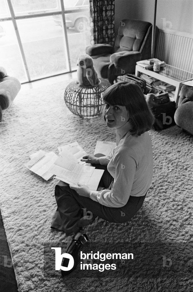 Pam Ayres replies to fan mail in her lounge at her home in a village in Oxfordshire. 12th May 1977 (b/w photo)