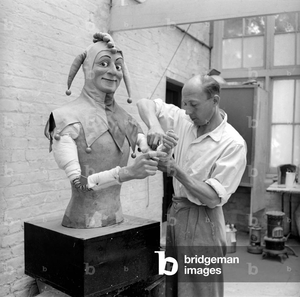 The workshop of a Midlands plastic figure factory, which manufacture a wide range of products from Puppets used in fairground amusements to shop mannequins. Our picture shows one of the craftsmen adding a few final touches to a Jester figure bound for a South Coast Pier January 1954 (b/w photo)