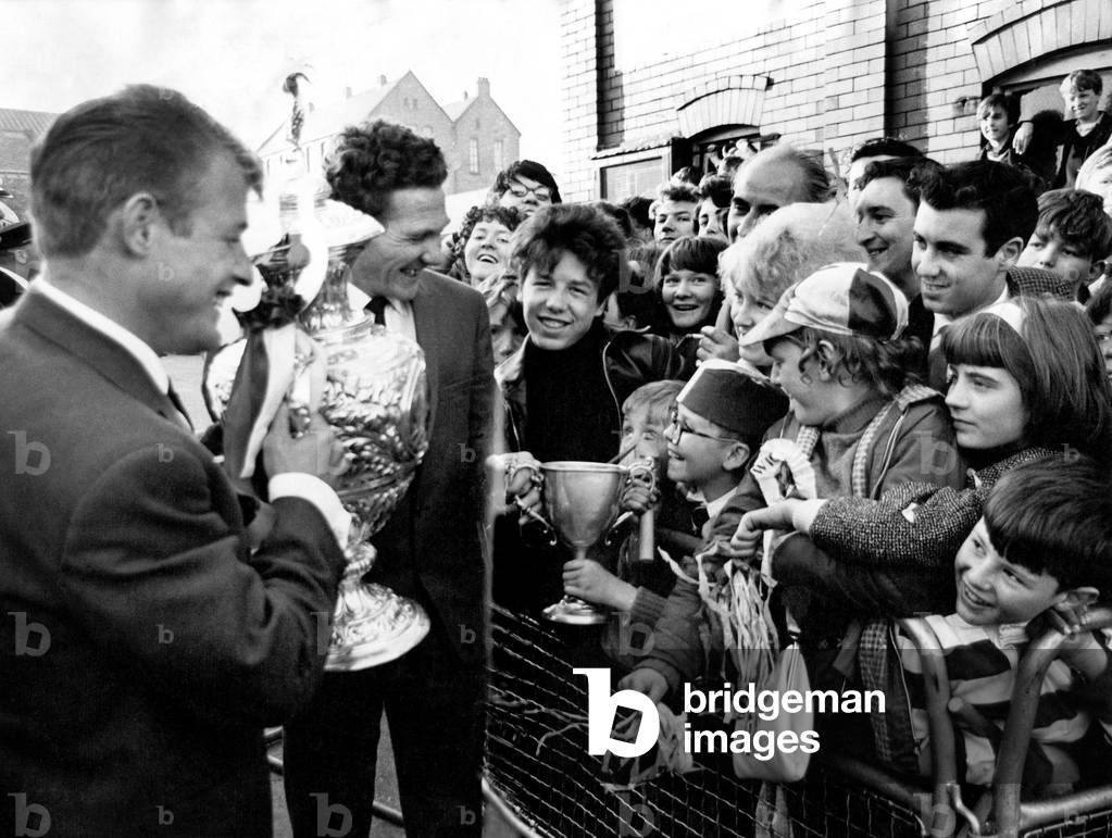 Wigan Rugby F.C. return. Frank Parr and Ray Ashby were showing the fans the Rugby League Challenge Cup at Central Park, Wigan to fans, and to their surprise 10 yr old Maurice Tait of Lymefield Flats, Wigan, offered up his prized fathers cup for fishing. (Ashby said he could not accept it.) May 1965
