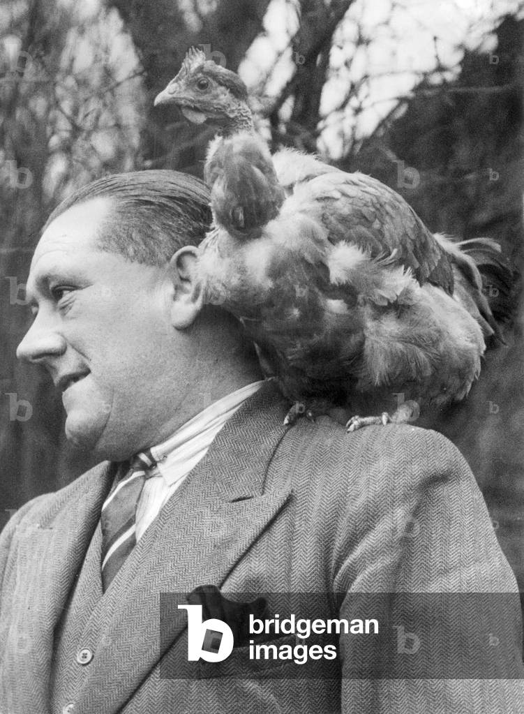 Cecil Parkin, cricketer for Lancashire and England. Pictured with his pet Churkey, Fu Fu, a cross between a chicken and a turkey. 1st January 1935 (b/w photo)