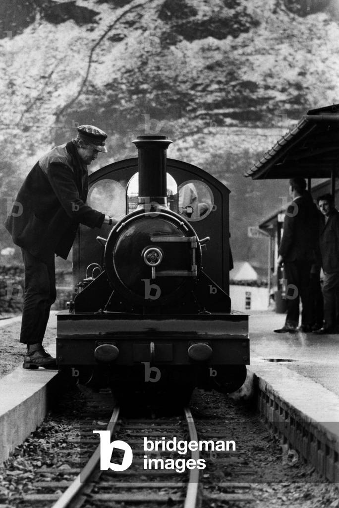 Dalegarth Station - the end of the line - driver George Staniforth checks the locomotive River Irt under the shadow of the snowclad Lakeland crags on 29th March 1972 (b/w photo)