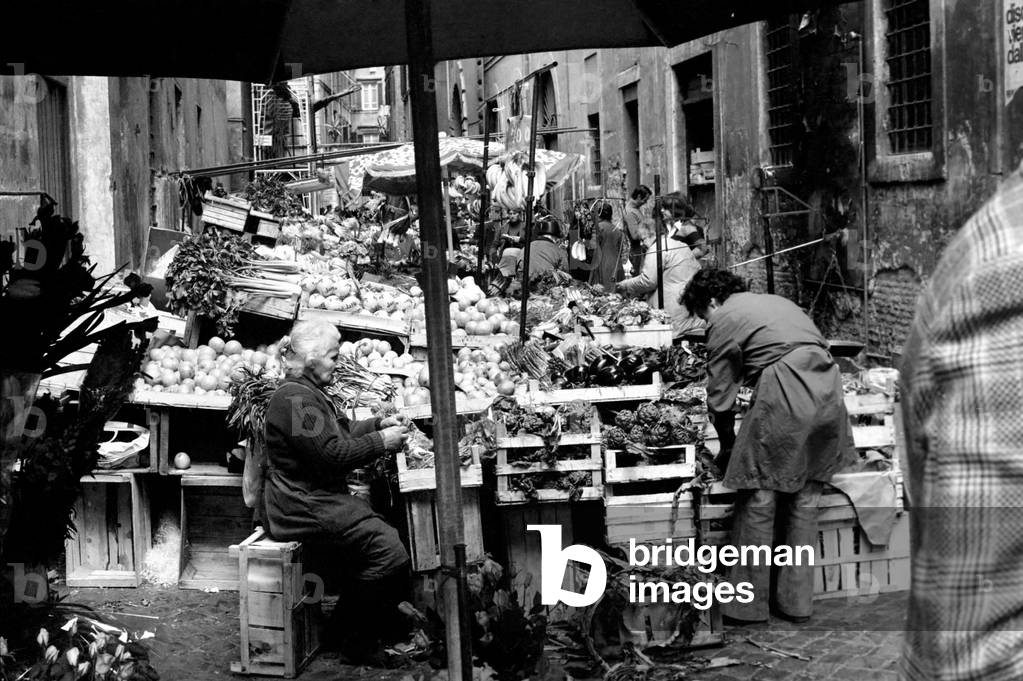 Woman buying fresh fruit and vegetables in a poor suburb on the outskirts of Rome, Italy, April 1975 (b/w photo)