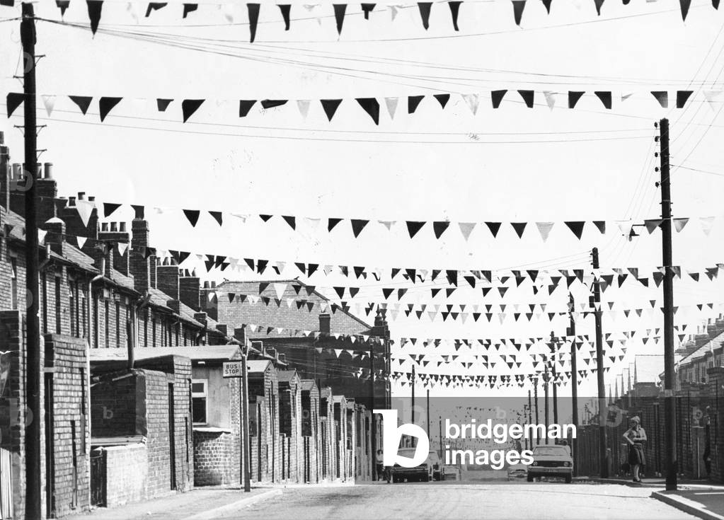 Flags adorning the streets of Quaking Houses, during the North East Leg of the Royal Jubilee Tour in 1977 (b/w photo)