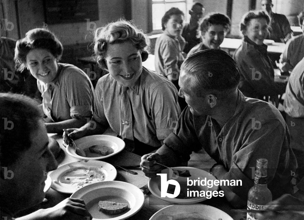Is it romance at the dinner table? Scene at a mixed AA Battery in the London area. July 1943