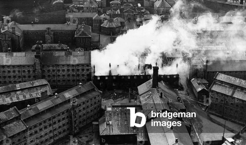 Dartmoor Prison is set on fire by mutineers in a riot, 1932 (b/w photo)