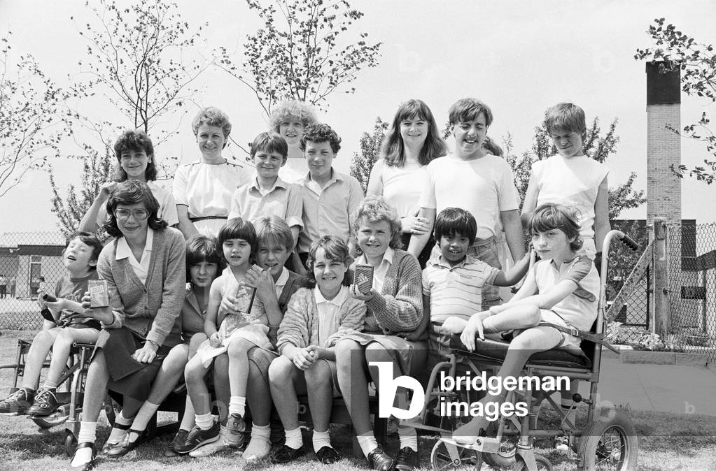 Members of the Pathfinders youth group at St Paul's church, Shepley, present tapes of disco music to youngsters at Turnshaws School, Kirkburton. The tapes were provided with money raised at a fashion show at the church hall, when Pathfinders and their leaders acted as models. The tapes were presented by leaders Carol Shore and Jane Robinson accompanied by Pathfinders Vicky Shore, Samantha Lees, Stephanie Rowe, Elizabeth Hudson, Karen Firth, Adrian Burrough and Darren Figg. 2nd July 1986 (b/w photo)