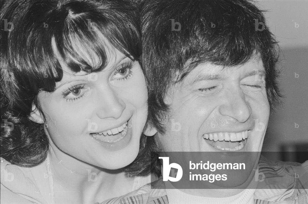 Actress Madeline Smith pictured at home with her boyfriend film actor David Buck. 10th August 1975 (b/w photo)