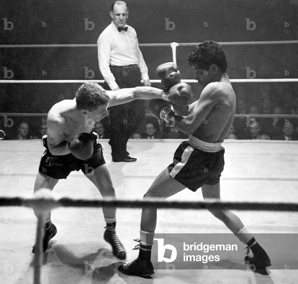 Boxing at Free Trade Hall, Manchester. Jackie Brown lands a left to the face of the Indian, Pancho Bhatachaji during last night's fight. Brown won on points. March 1960 P011465