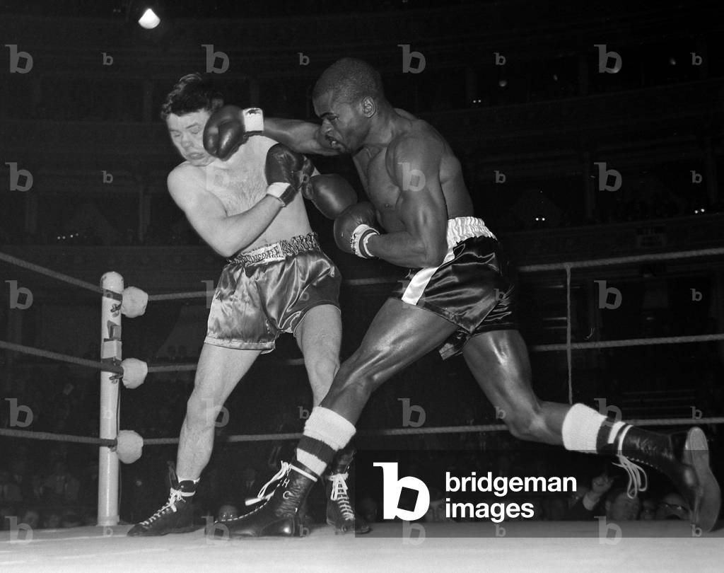American middleweight boxer Rubin Hurricane Carter of New Jersey, USA, in action during his fight with Harry Scott of Bootle at the Royal Albert Hall. April 1965