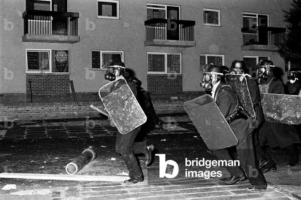 Policeman wearing gas masks and shields prepare a baton charge at during the Londonderry riots in Northern Ireland. August 1969
