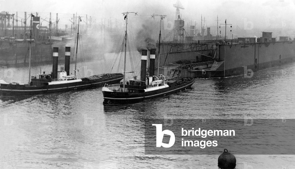 The 13,000 miles ahead the floating dock built at Wallsend for New Zealand is seen gliding down to Tyne at the start of its record journey in 1931