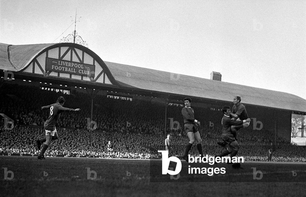 Bobby Charlton of Manchester United crashes in to Liverpool player Tommy Smith after winning a header during their league match at Anfield. 17th October 1968 (photo)