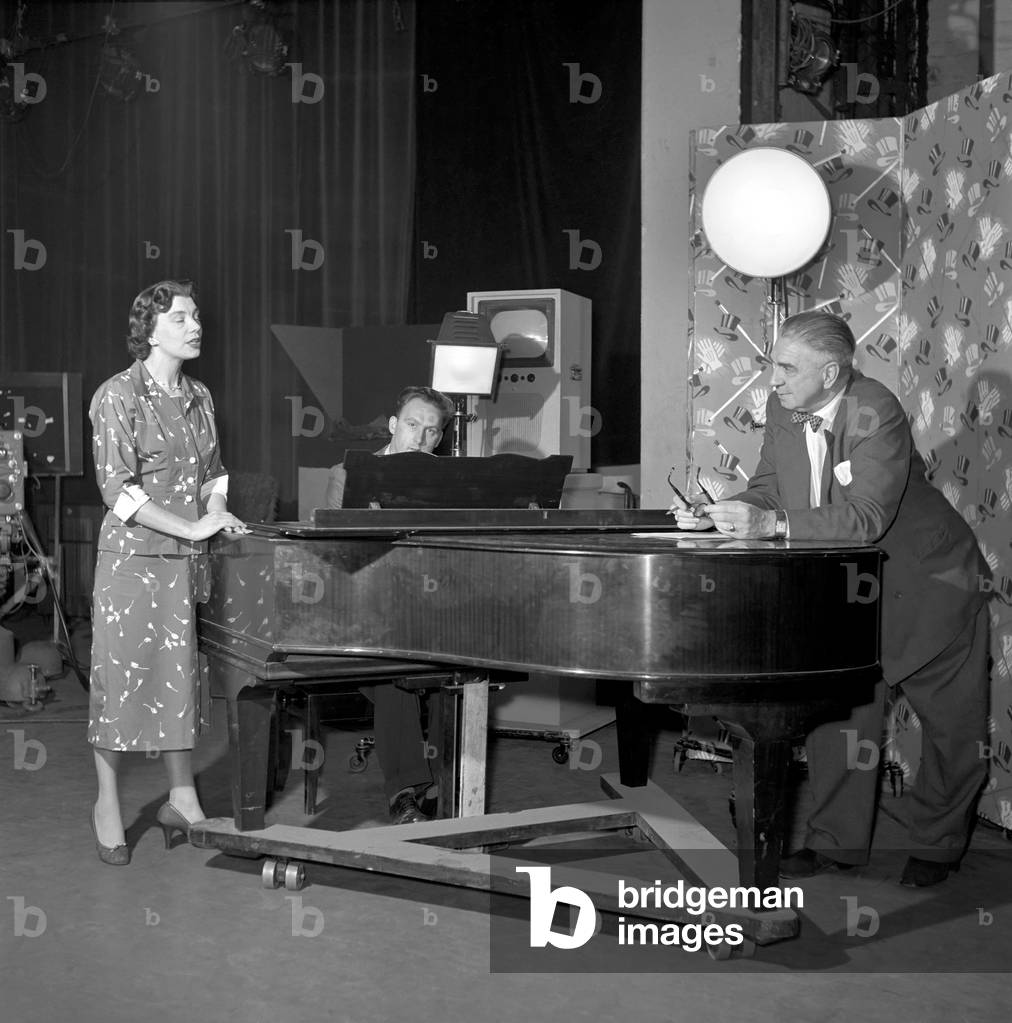 TV presenter Fred Wilby seen here beside the piano in the studios of Midland TV, January 1957 (b/w photo)