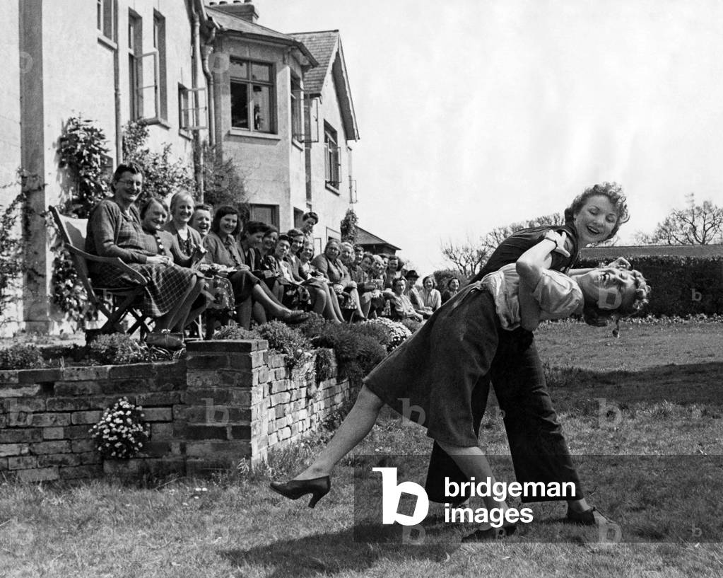 Women munitions workers dance the jitterbug at a tea dance, 19th April 1943 (b/w photo)