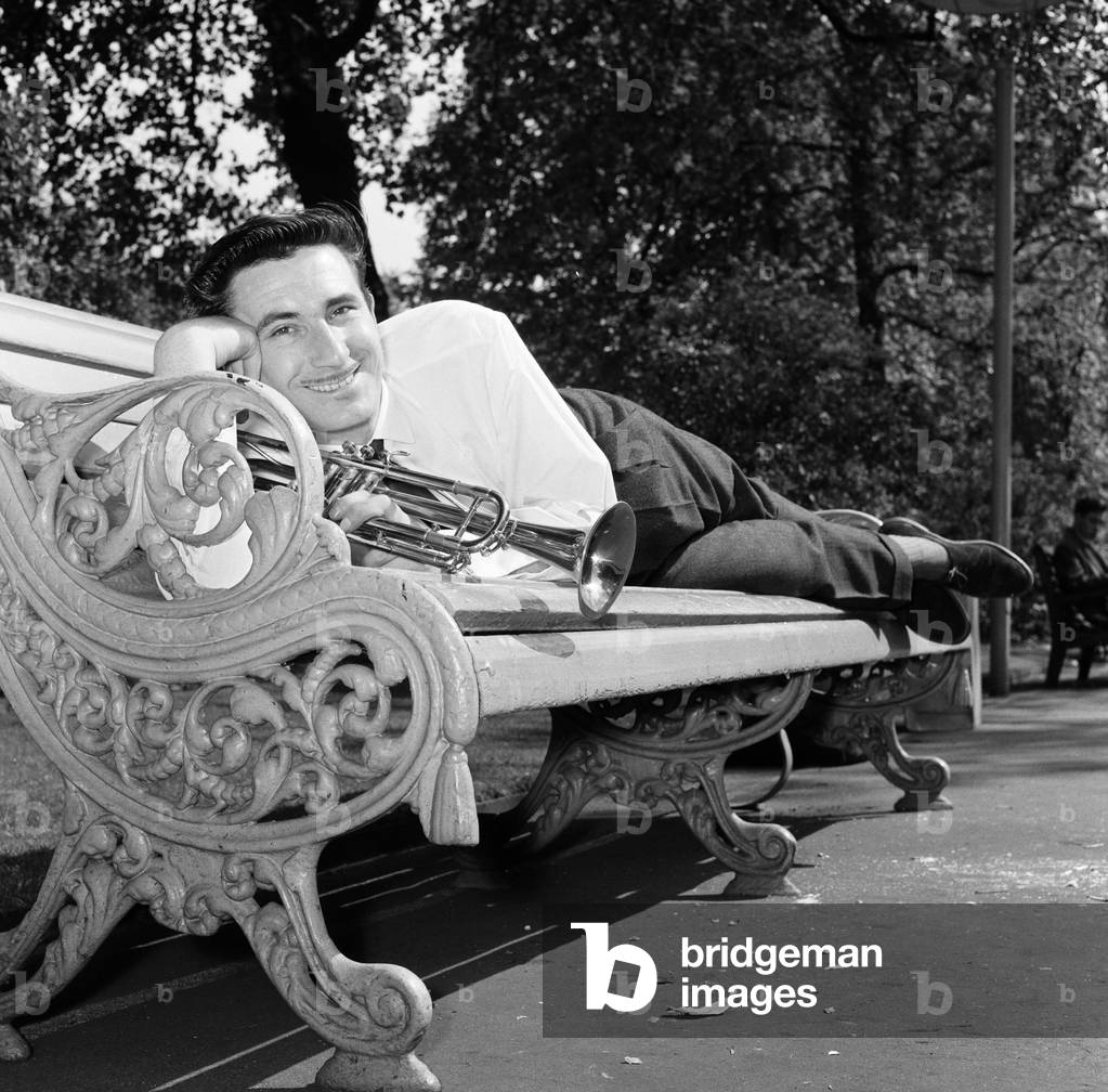 Jazz trumpeter Kenny Ball pictured in London's Embankment gardens during rehearsals.
13th June 1962.