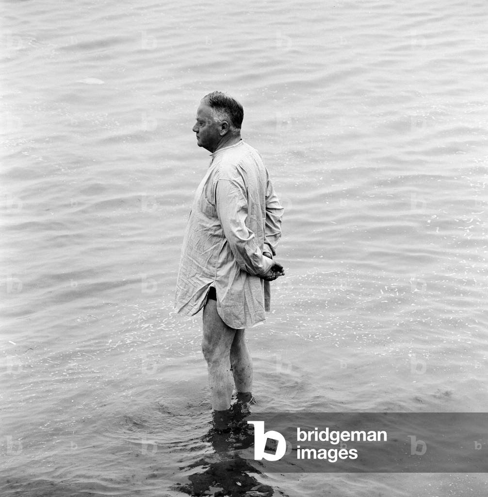 A holidaymaker paddles in the sea on the beach at Margate during the Summer holidays. 3rd August 1961 (b/w photo)