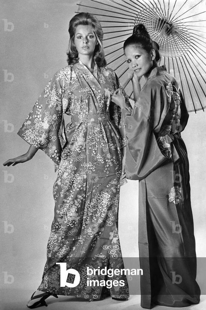 East meets West under a traditional oiled paper umbrella. Willow (right) wears a glowing red silk kimono with a brilliant splash of embroidery on the back, price .50. NinaÍs kimono is Pacific blue patterned with flowers, price .50. Umbrella, .50. All are available from Mitsukiku, 73a Lower Sloane Street, London, S.W.1, and 18 Brighton Square, Brighton. Postage and packing 20p extra for kimonos, 30p for parasol. January 1973