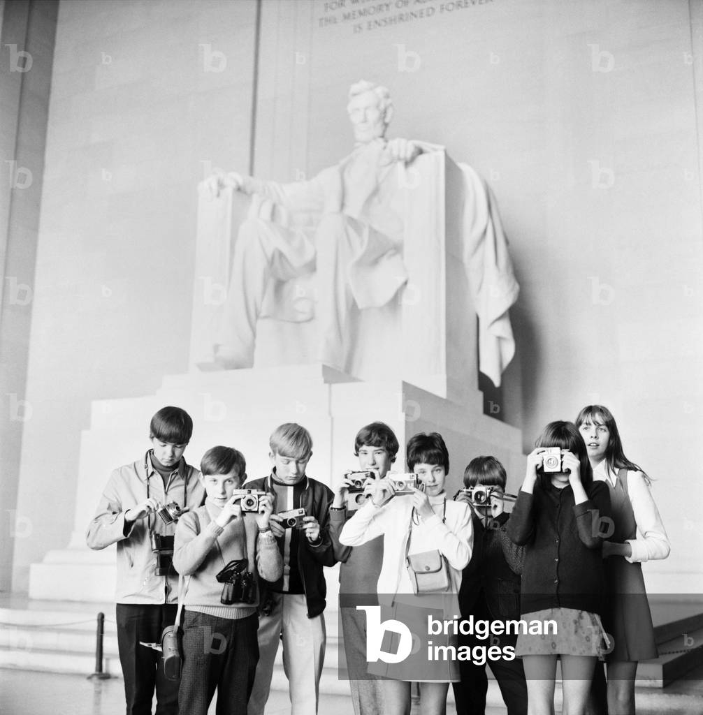 Holiday makers with their cameras, pictured in Washington, by Abraham Lincoln's monument in Washington, USA. November 1969