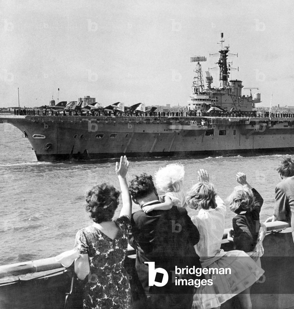 People waving at the visiting aircraft carrier HMS Centaur. Liverpool, Merseyside. 14th August 1965.