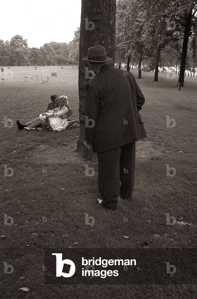 A Couple Kissing in the park all the while being watched by a dirty old man
Courting couple touching each other on a park bench
Voyeur Stalking
August 1960