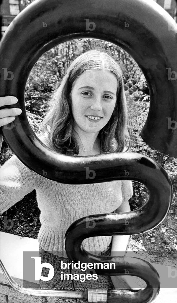 Secretary Ann Roger got to grips with an early musical instrument called the Serpent which is on display at the Laing Arts Gallery, June 1974 (b/w photo)