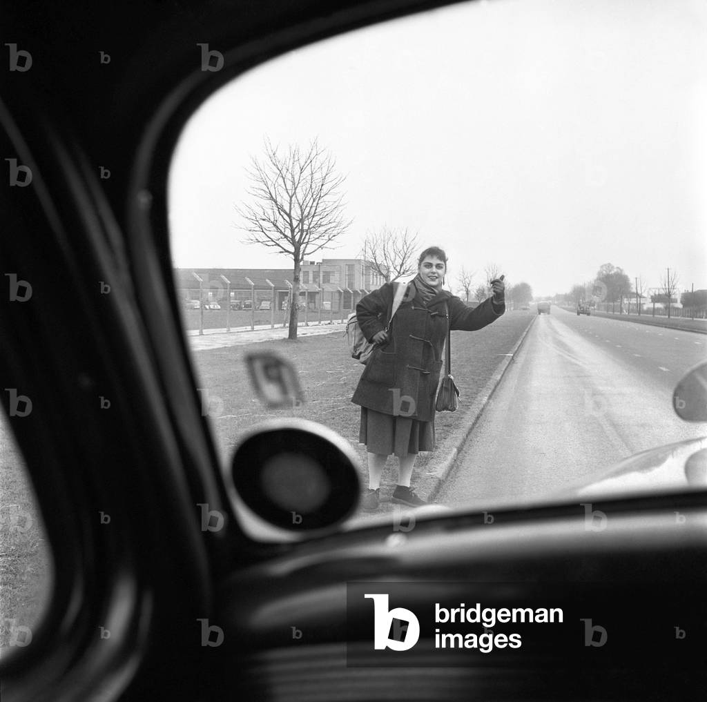 Girl hitch-hiking on the A30. to Southampton, c. 1957 (b/w photo)
